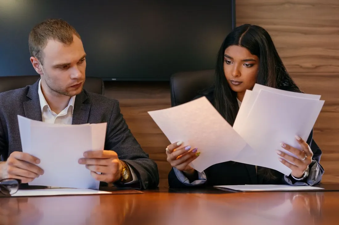 People examining paperwork together at a desk